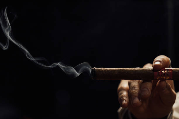 Man smoking cigar with smoke on a black background Про TobakPro – постачальник сигарет та алкоголю в Україні